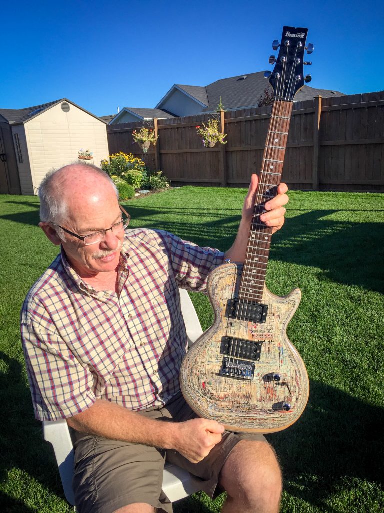 Cousin Gerald with his guitar made of magazine paper